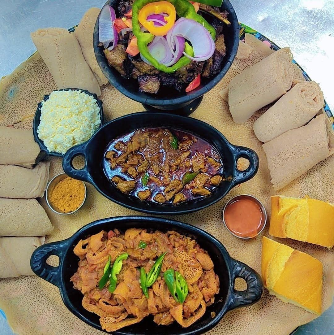 Ethiopian combination platter with grilled tibs, dulet, ayib cottage cheese and rolled injera