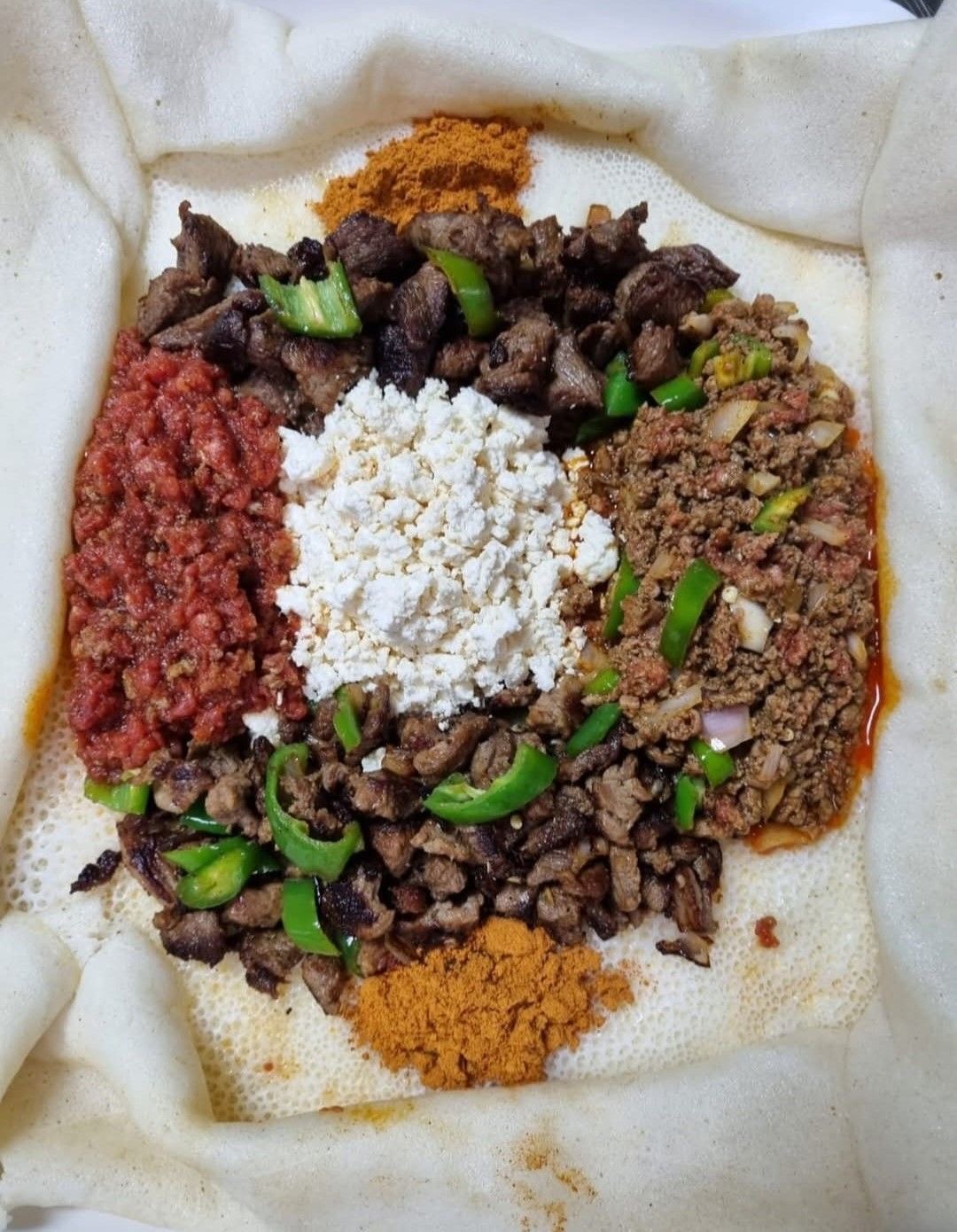 Ethiopian kitfo, finely minced spiced beef served with injera