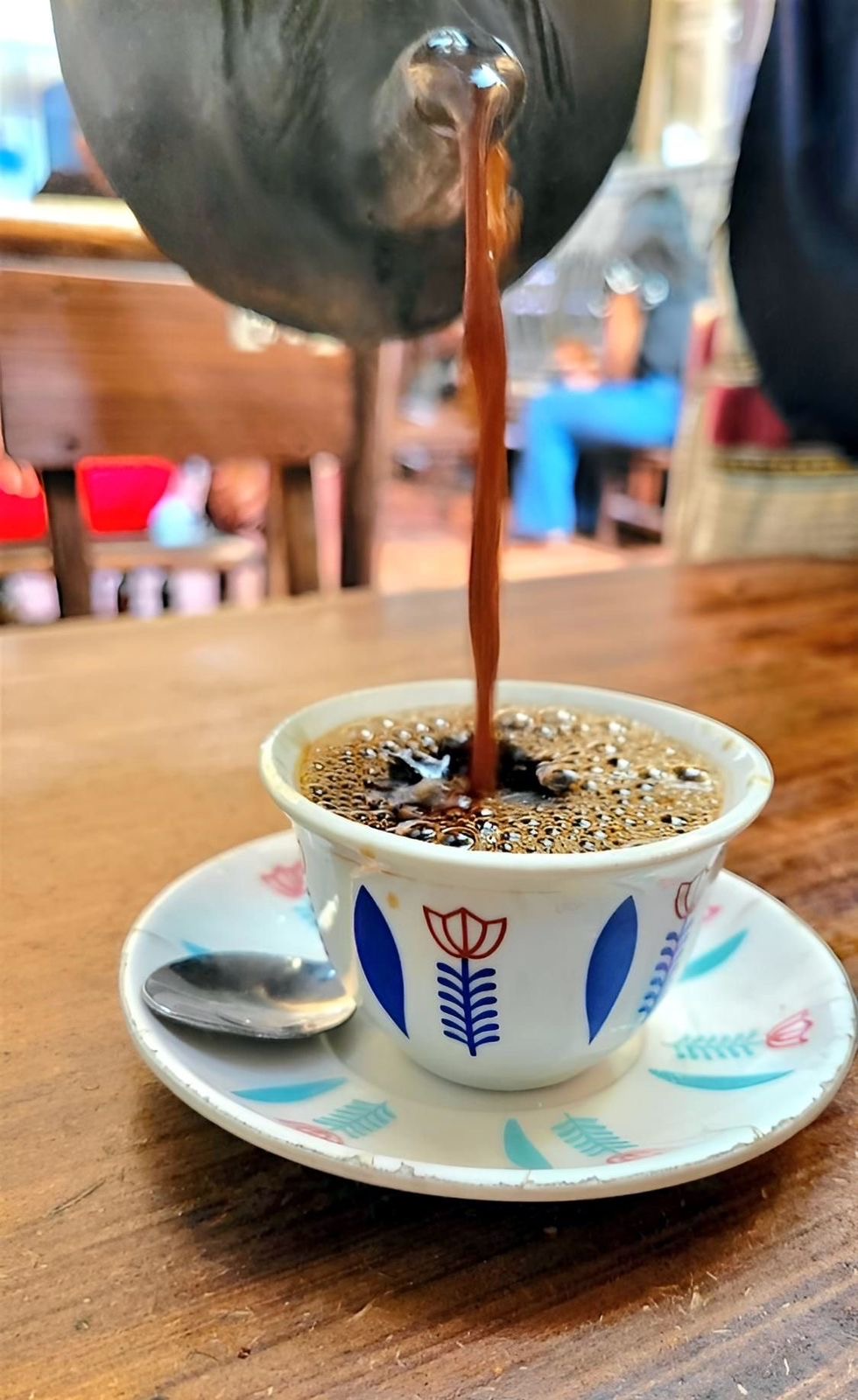 Ethiopian bunna coffee poured from a jebena into small cups